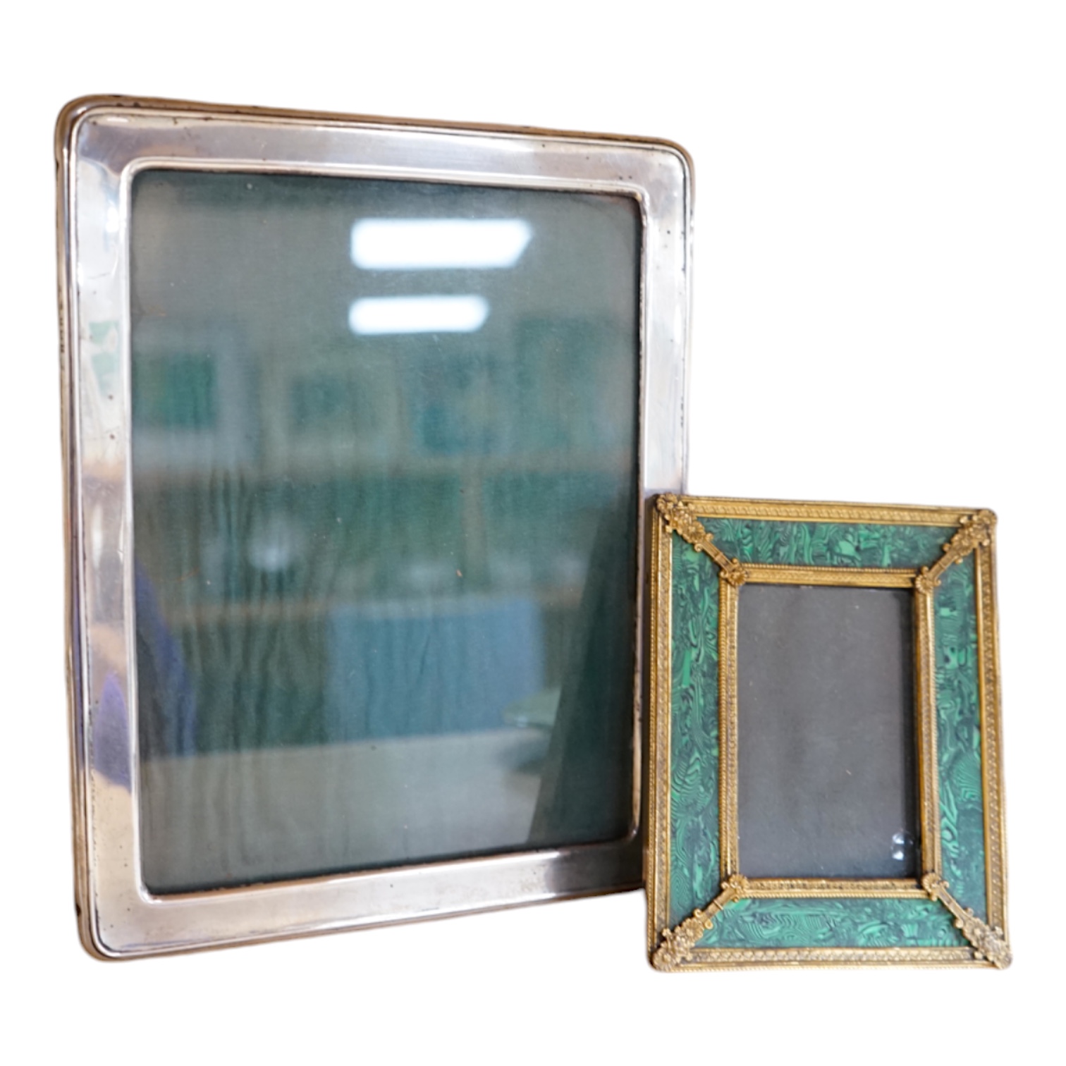 An early 20th century silver mounted photograph frame and a faux malachite gilt easel frame, largest 24cm high. Condition - fair